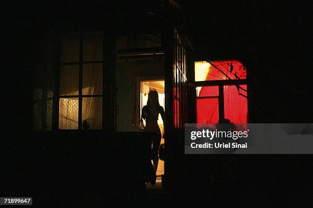 Khazak prostitute stands in the door of a brothel August 10, 2006 in Almaty in the central Asian country of Kazakhstan. Fifteen years after the...