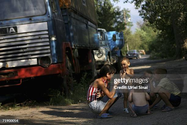 Khazak children play in the shade near the Icic river canal August 9, 2006 in Icic, a town about an hours drive from Almaty in the central Asian...