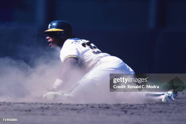 Rickey Henderson of the Oakland A's stealing a base during a game In August at the Oakland-Alamdea County Stadium.