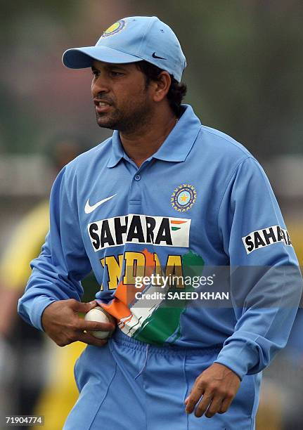 Kuala Lumpur, MALAYSIA: India's star batsman sachin Tendulkar shine up a ball for his pacer in the third one-day of the DLF triangular series in...