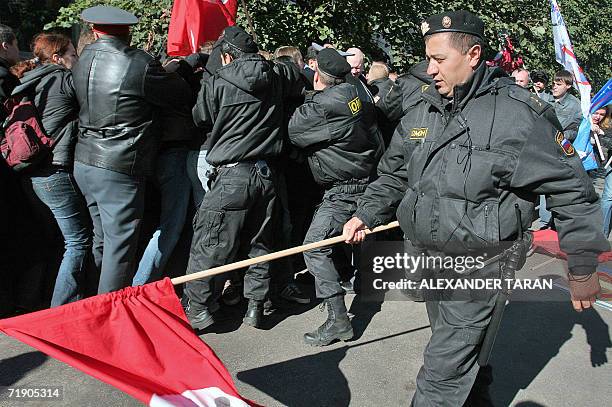 St Petersburg, RUSSIAN FEDERATION: Russian special police forces officer carries a red flag as his colleagues arrest a participants of human rights...