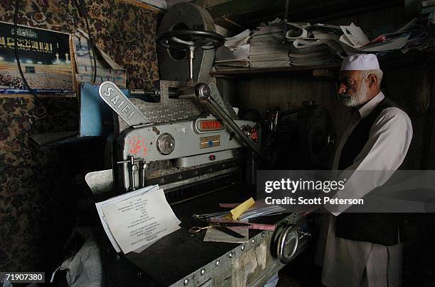 Man examines his old printing press September 16, 2006 in Kabul, Afghanistan. Five years after the fall of the Islamist Taliban militia, NATO troops...