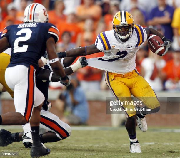 Quarterback JaMarcus Russell of the Louisiana State University Tigers looks to avoid a tackle by Aairon Savage of the Auburn University Tigers...