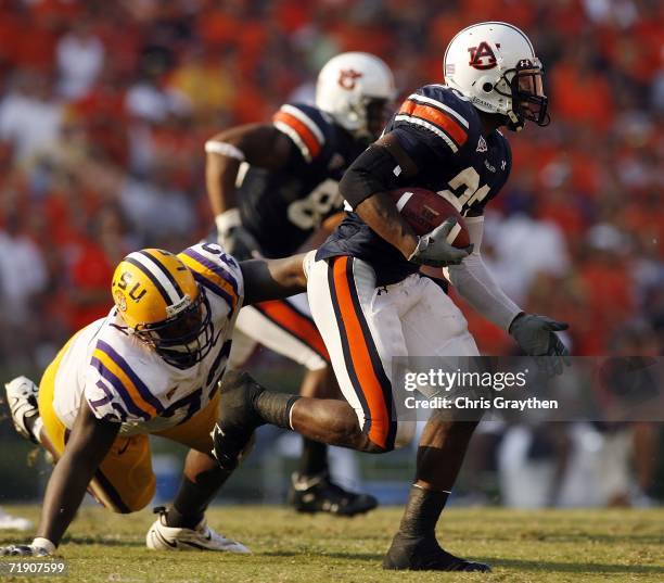 Kenny Irons of the Auburn University Tigers avoids a tackle by Glenn Dorsey of the Louisiana State University Tigers September 16, 2006 at...