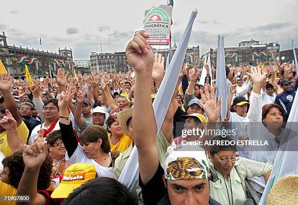 Delegates and supporters of Mexican leftist former presidential candidate Andres Manuel Lopez Obrador, raise their hands to vote during the National...