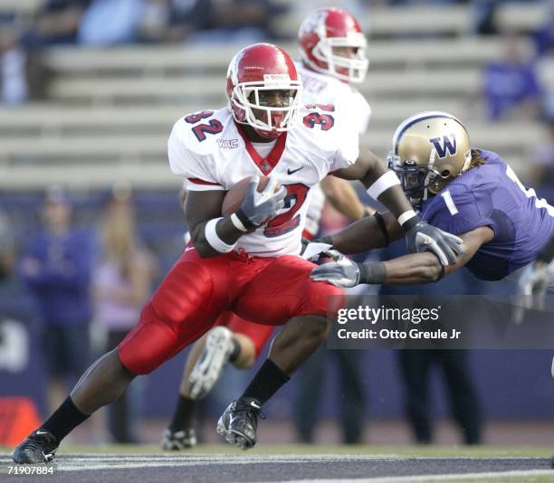 Runningback Dwayne Wright of the Fresno State Bulldogs rushes against C.J. Wallace of the Washington Huskies on September 16, 2006 at Husky Stadium...