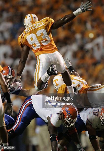 Defensive end Xavier Mitchell and Turk McBride of the Tennessee Volunteers try to block a field goal over offensive lineman Jason Watkins of the...