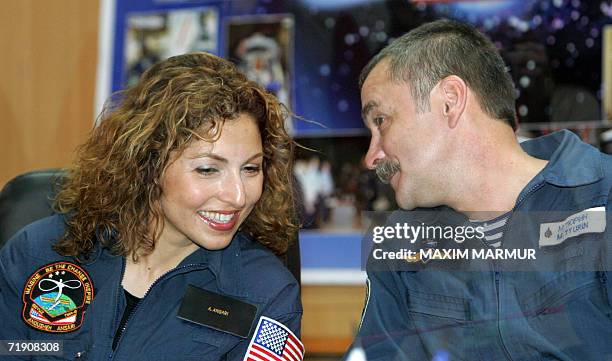 The world's first female space tourist Anoushen Ansari listens to Russian cosmonaut Mikhail Tyurin during a press conference in Baikonur, 17...