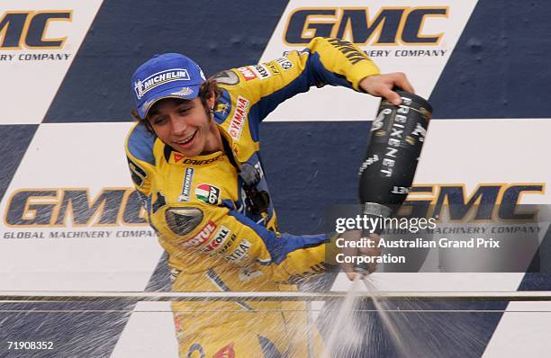Valentino Rossi of Italy and Camel Yamaha celebrates taking third place by spraying champagne on the podium during the presentation for the 2006 GMC...