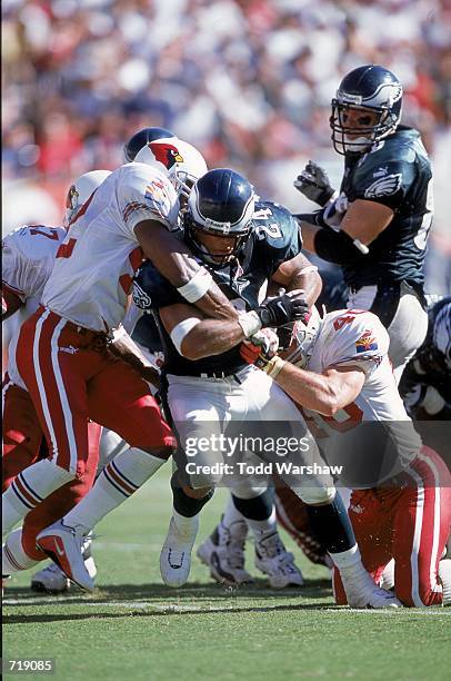 Darnell Autry of the Philadelphia Eagles gets pulled down by Pat Tillman of the Arizona Cadinals during the game at the Sun Devil Stadium in Tempe,...