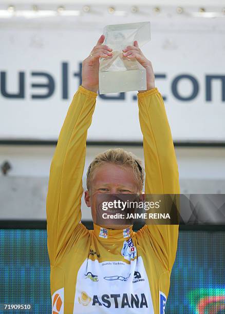 Astana rider Alexandre Vinokourov holds aloft the trophy after winning the Tour of Spain in Madrid, 15 September 2006. For the 33-year-old Astana...