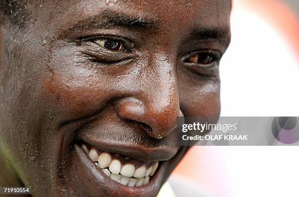 Amsterdam, NETHERLANDS: Dutch Record-breaking runner, formerly of Kenya, Lornah Kiplagat smiles after winning the 22nd Dam to Dam marathon from...