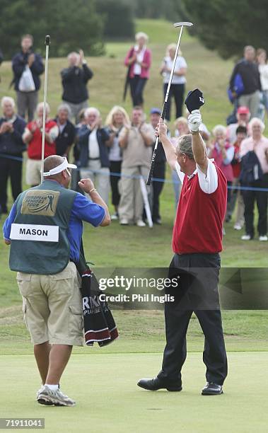 Carl Mason of England is congratulated by his caddie Neil Loveless after the final round of the Midas Group English Seniors Open played over the St...