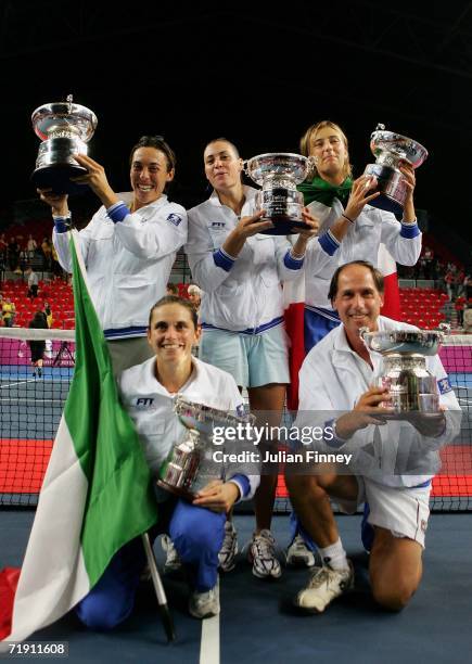 Francesca Schiavone, Flavia Pennetta, Mara Santangelo, Roberta Vinci and Coach Corrado Barazzutti of Italy celebrate defeating Belgium after the Fed...