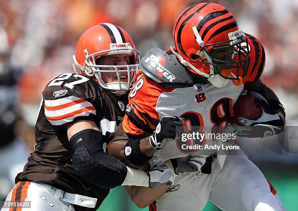 Brian Russell of the Cleveland Browns tackles Tab Perry of the Cincinnati Bengals on September 17, 2006 at Paul Brown Stadium in Cincinnati, Ohio....