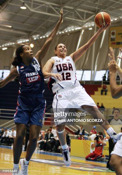 Diana Taurasi of USA jumps to score as France's Nathalie Lesdema tries to block her during their FIBA World Championship for Women Brazil 2006, 17...