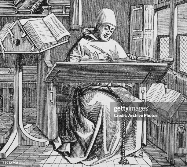 Medieval scribe writes at his desk, surrounded by open manuscripts, 15th Century.