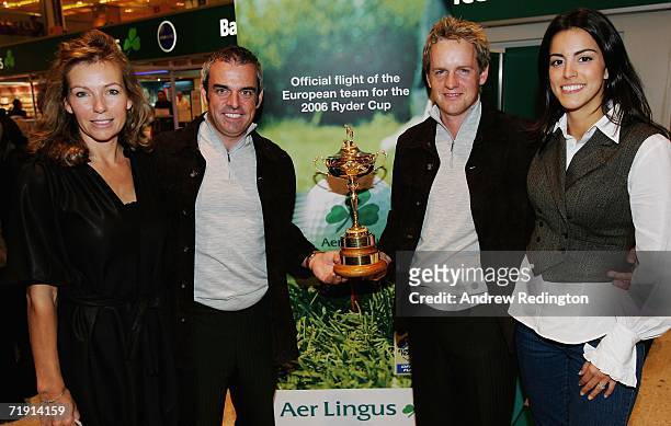 Alison McGinley, Paul McGinley of Ireland, Luke Donald of England and Diane Antonopoulos pose with the Ryder Cup Trophy as they arrive at Heathrow...