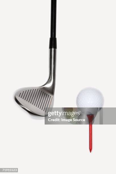 golf club with golf ball on a tee - iron stock-fotos und bilder