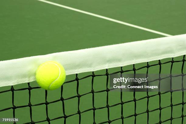 tennis ball on court - tennis net stock pictures, royalty-free photos & images