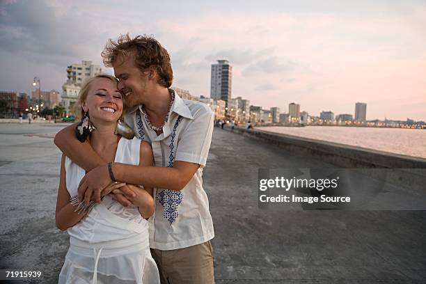 loving couple on coastal boulevard - havana nights stock pictures, royalty-free photos & images