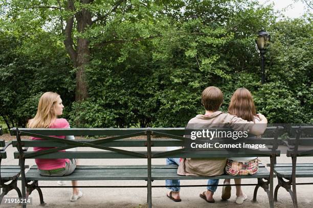 jealous girl looking at a couple - covet stock pictures, royalty-free photos & images