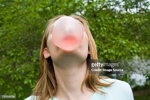 teenage girl blowing a bubble gum bubble - bubble gum bubble stock pictures, royalty-free photos & images