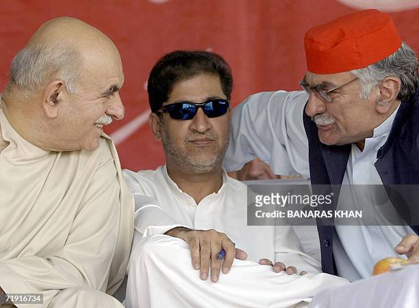 Pakistani opposition party leader Sardar Akhtar Mangel listens to opposition leaders Mahmood Khan Achakzai and Asfandyar Wali Khan during a public...