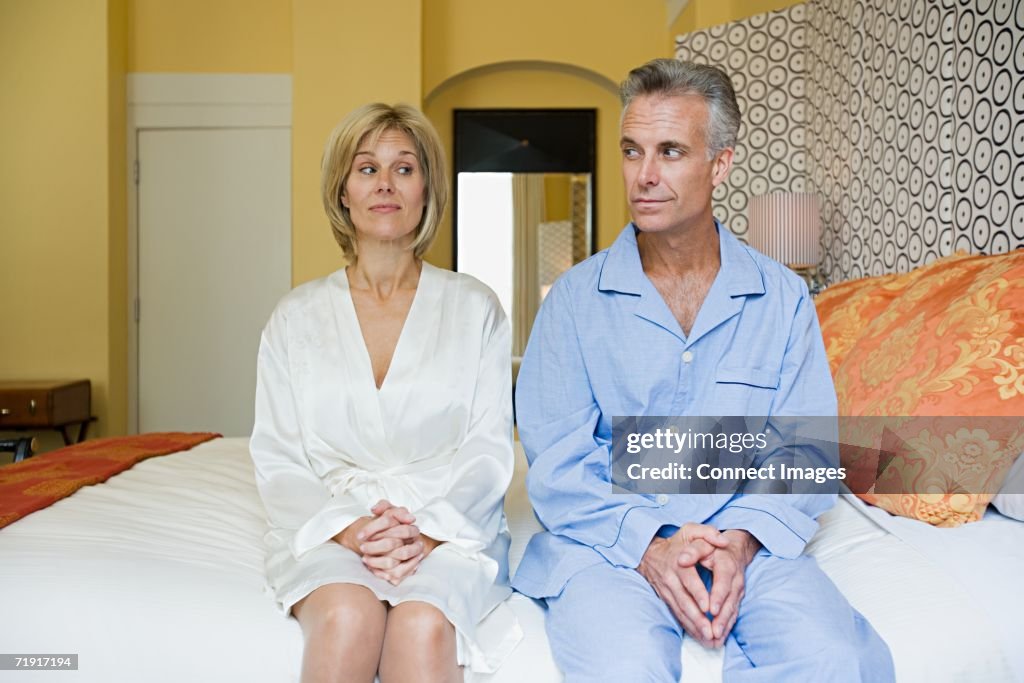 Couple sitting on bed