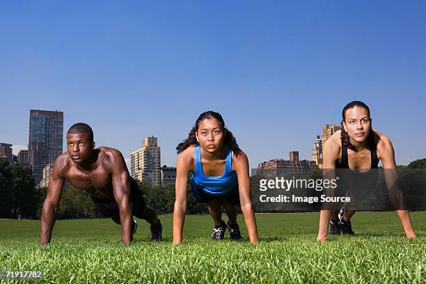 press ups in central park - three storey stock pictures, royalty-free photos & images