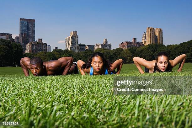 press ups in central park - three storey stock pictures, royalty-free photos & images