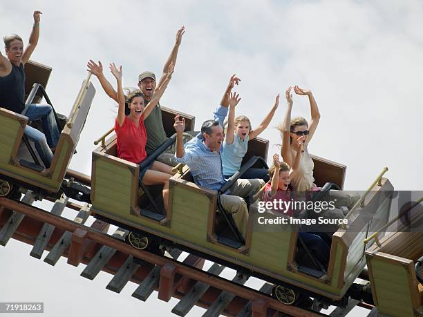 people on a rollercoaster - montaña rusa fotografías e imágenes de stock