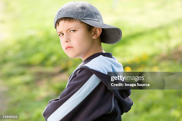 sulking boy on field - back to front stock pictures, royalty-free photos & images