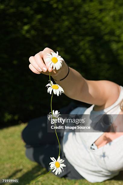 woman holding a daisy chain - daisy chain stock pictures, royalty-free photos & images