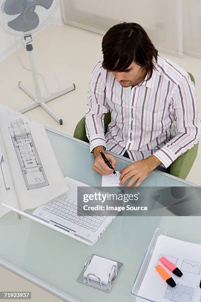 man making a note - electric fan paper stock pictures, royalty-free photos & images
