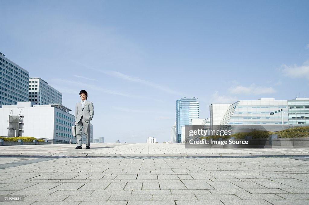 Businessman walking through financial district