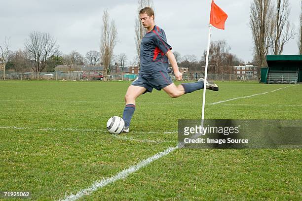 footballer taking a corner kick - corner kick stock-fotos und bilder