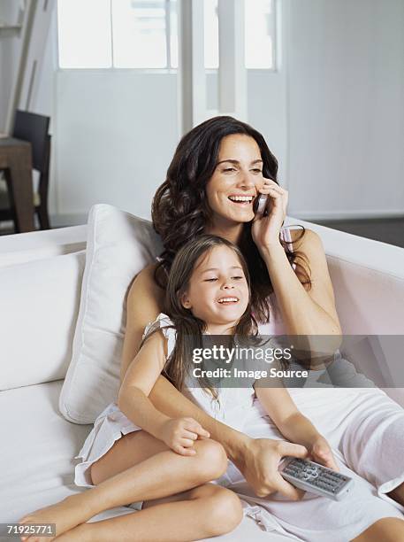 mother and daughter sat on sofa - sattel bildbanksfoton och bilder