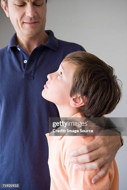 son looking up to father - un certain regard stock pictures, royalty-free photos & images