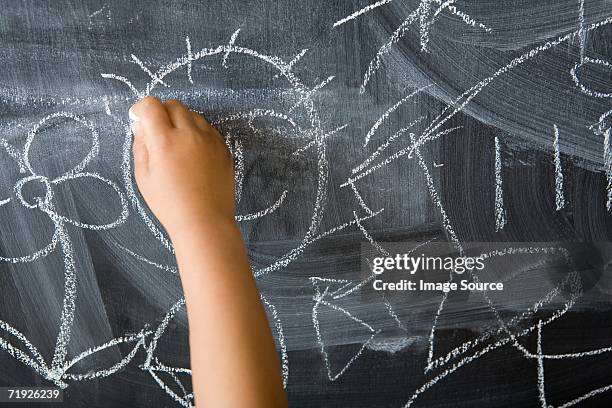 child drawing on blackboard - chalk hands stock pictures, royalty-free photos & images