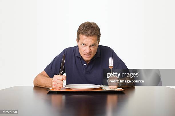 angry man waiting for meal - hungry stock-fotos und bilder