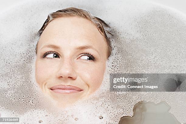 girl in a bubble bath - bubblebath stock pictures, royalty-free photos & images