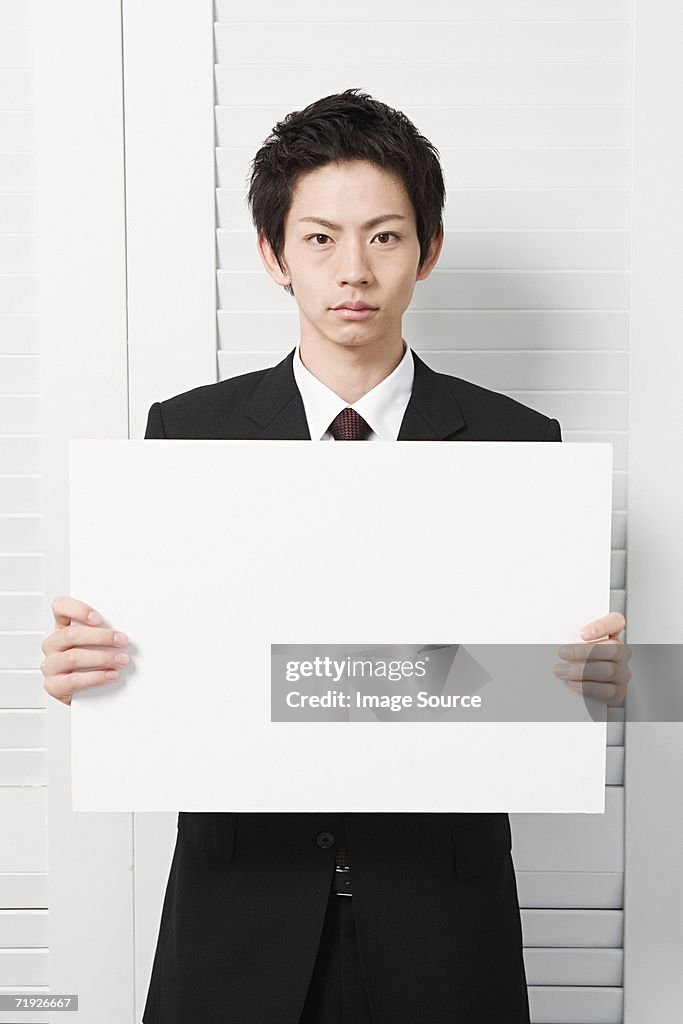 Businessman holding a blank sign