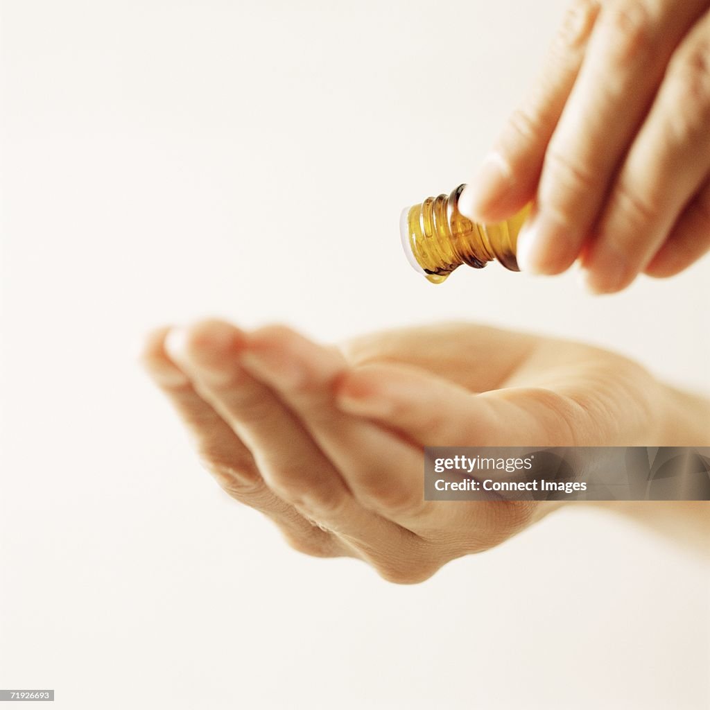 Woman pouring essential oil