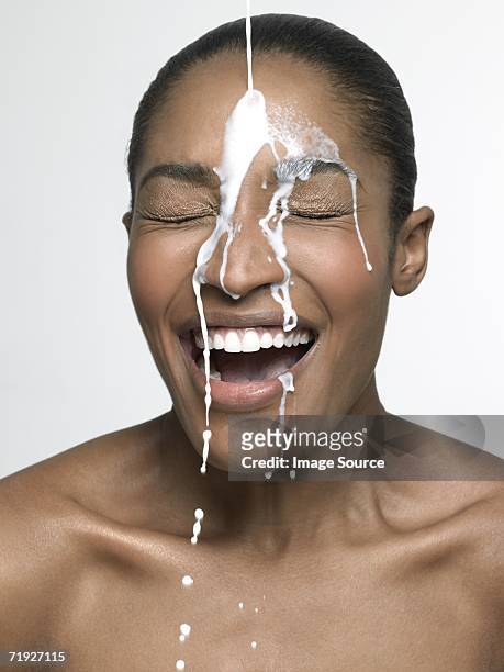 milk pouring onto woman - milk pour white background bildbanksfoton och bilder