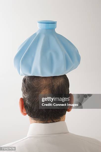 man with ice pack on his head - ice pack stock pictures, royalty-free photos & images