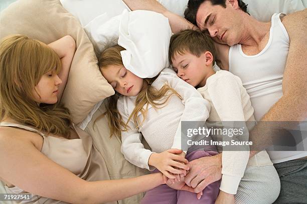 sleeping family - double bed stock pictures, royalty-free photos & images