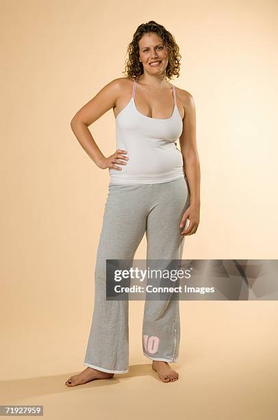 woman with hand on hip - woman jogging pants stock pictures, royalty-free photos & images