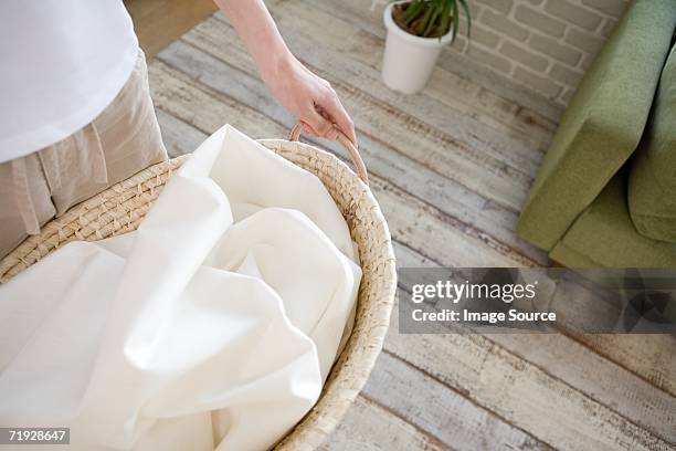 woman with laundry - washing basket stock pictures, royalty-free photos & images