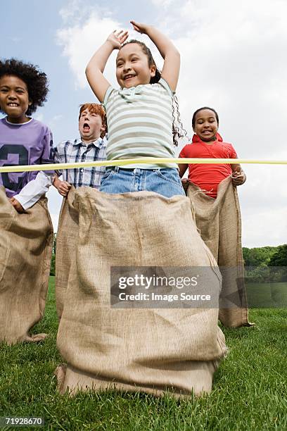 girl winning sack race - sack race stock pictures, royalty-free photos & images